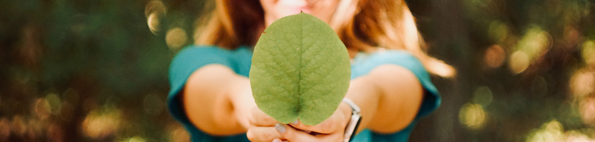 Woman holding leaf