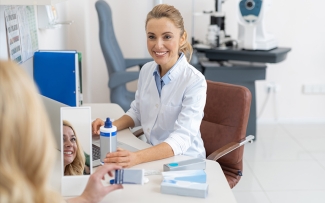 woman optician at desk recommending contact lenses